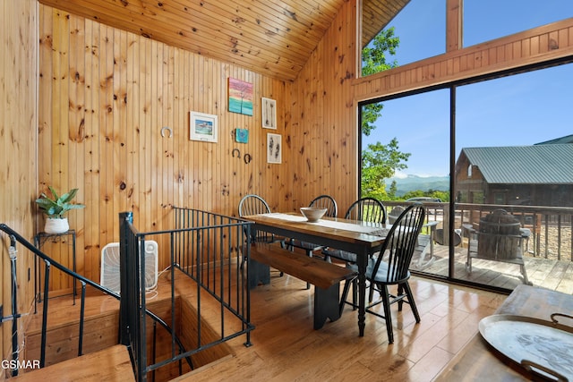 2295 Bluff Mountain Rd, Sevierville, TN 37876 - dining space with plenty of natural light, wooden walls, hardwood / wood-style floors, a mountain view, and high vaulted ceiling
