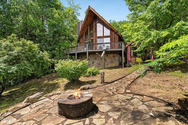 2295 Bluff Mountain Rd, Sevierville, TN 37876 - back of property with an outdoor fire pit, a chimney, a deck, and a patio