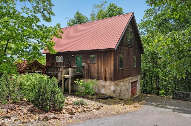 2295 Bluff Mountain Rd, Sevierville, TN 37876 - rustic home featuring a garage, driveway, metal roof, stairs, and stone siding