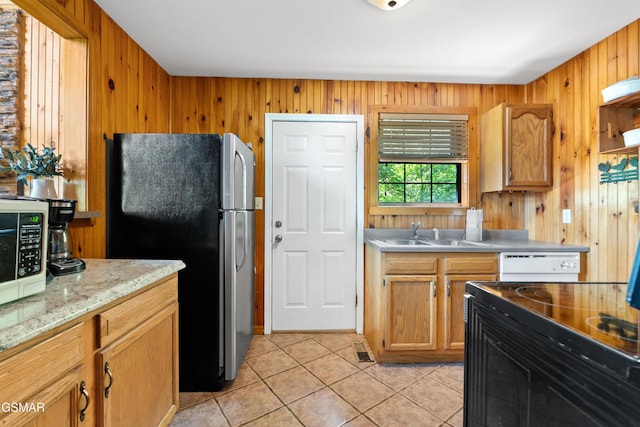 2295 Bluff Mountain Rd, Sevierville, TN 37876 - kitchen with freestanding refrigerator, a sink, light tile patterned floors, wooden walls, and white microwave