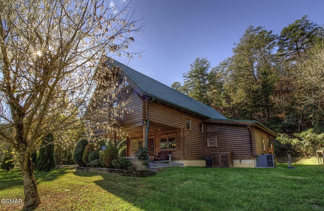 view of side of home with a yard and central air condition unit