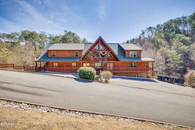 log-style house with covered porch