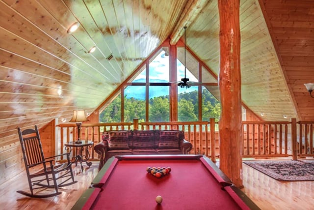 game room featuring vaulted ceiling with beams, wood walls, wood ceiling, and pool table