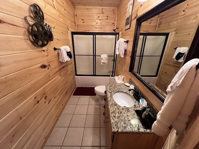 full bathroom with tile patterned floors, wood walls, shower / bath combination with glass door, vanity, and wood ceiling