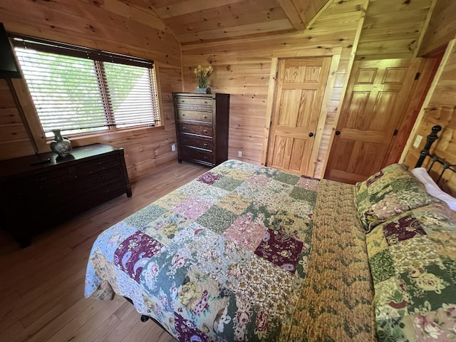 bedroom featuring wooden ceiling, wood walls, wood-type flooring, and vaulted ceiling