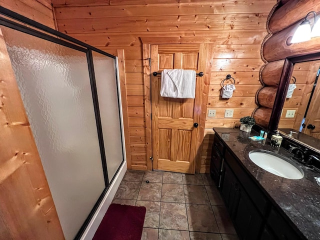 bathroom featuring tile patterned flooring, wood walls, and an enclosed shower