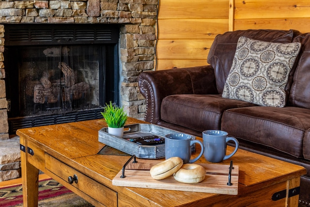 living area with a stone fireplace