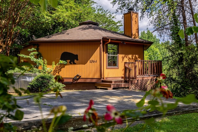 back of house with a patio and a wooden deck