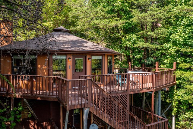 rear view of house with a gazebo and a deck