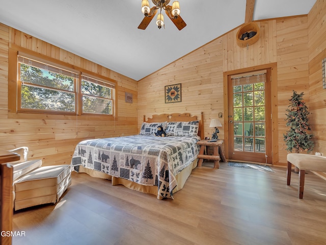 1518 Ridgecrest Dr, Sevierville, TN 37876 - bedroom with wooden walls, lofted ceiling, multiple windows, access to exterior, and wood finished floors