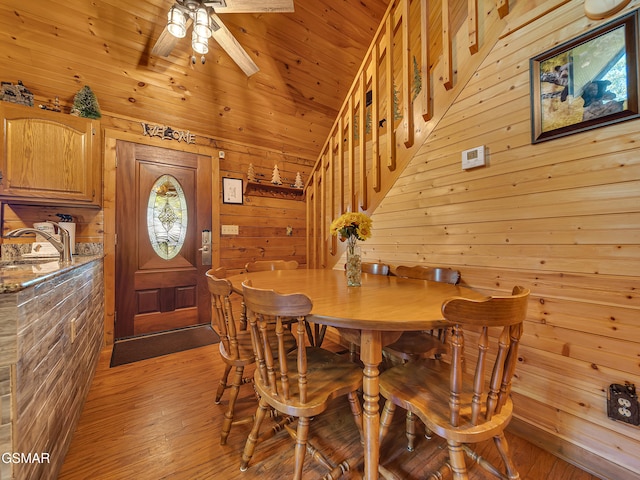 1518 Ridgecrest Dr, Sevierville, TN 37876 - dining room with wood walls, light wood-type flooring, a ceiling fan, vaulted ceiling, and stairway