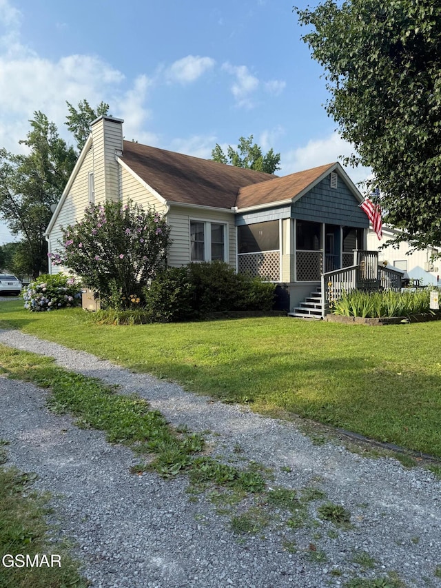 211 Valley Dr, Pigeon Forge, TN 37863 - view of front of home featuring a front lawn and a chimney