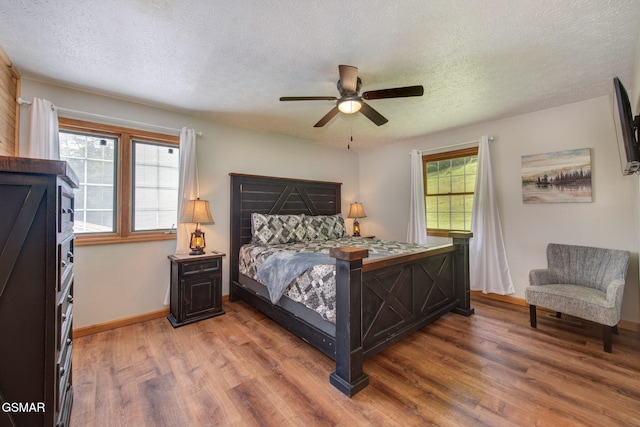 1315 Mccarter Hollow Rd, Sevierville, TN 37862 - bedroom with light wood-type flooring, a textured ceiling, and a ceiling fan