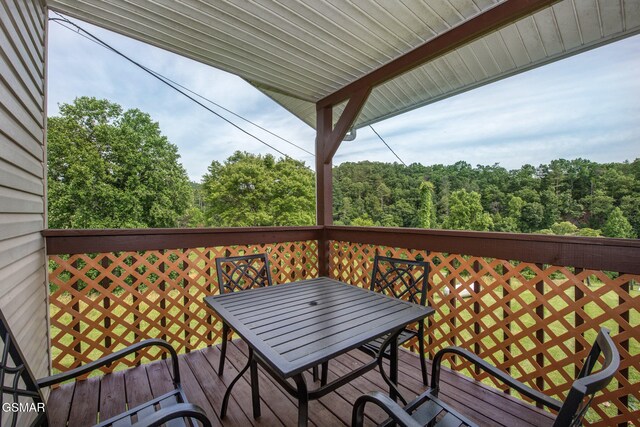 1315 Mccarter Hollow Rd, Sevierville, TN 37862 - wooden deck featuring outdoor dining area and a forest view