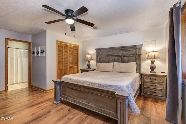 1315 Mccarter Hollow Rd, Sevierville, TN 37862 - bedroom with wood finished floors, a textured ceiling, a closet, and a ceiling fan