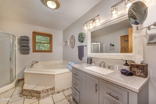 1315 Mccarter Hollow Rd, Sevierville, TN 37862 - full bathroom featuring vanity, a shower stall, tile patterned floors, a garden tub, and a textured ceiling