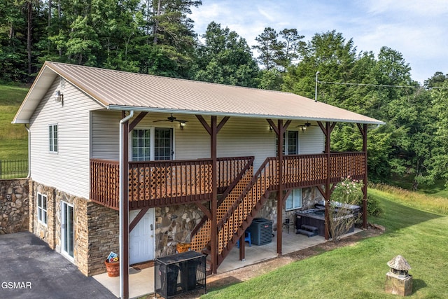 1315 Mccarter Hollow Rd, Sevierville, TN 37862 - view of front of property featuring a ceiling fan, stone siding, a front lawn, a patio, and an attached garage