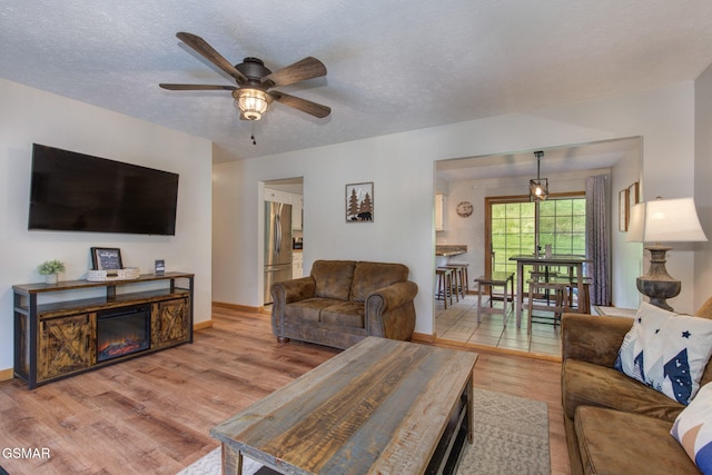 1315 Mccarter Hollow Rd, Sevierville, TN 37862 - living area with a ceiling fan, wood finished floors, and a textured ceiling
