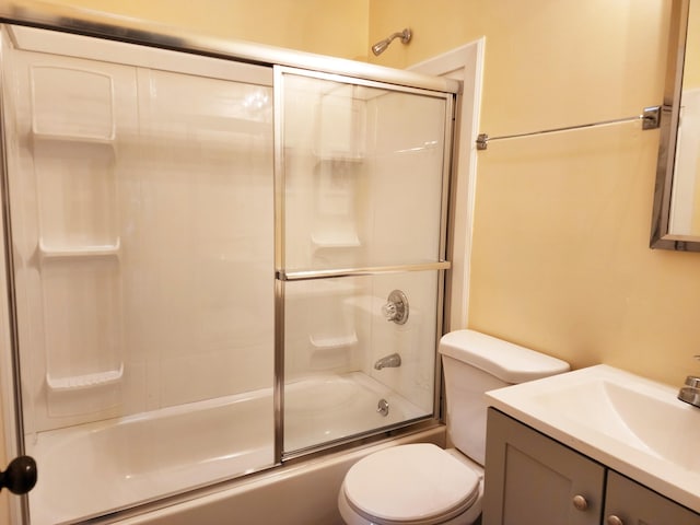 full bathroom featuring toilet, vanity, and combined bath / shower with glass door