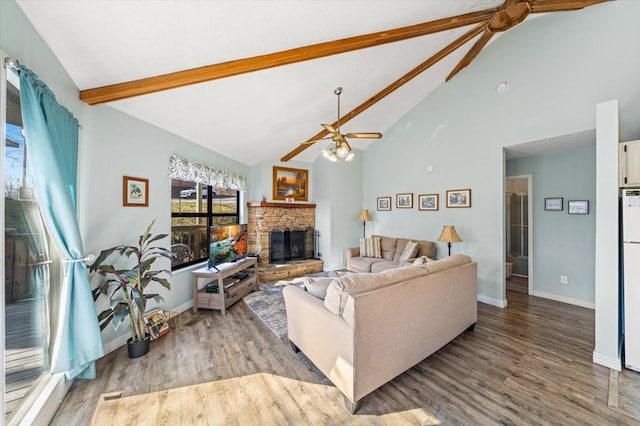 living room featuring beamed ceiling, light wood-type flooring, high vaulted ceiling, and ceiling fan