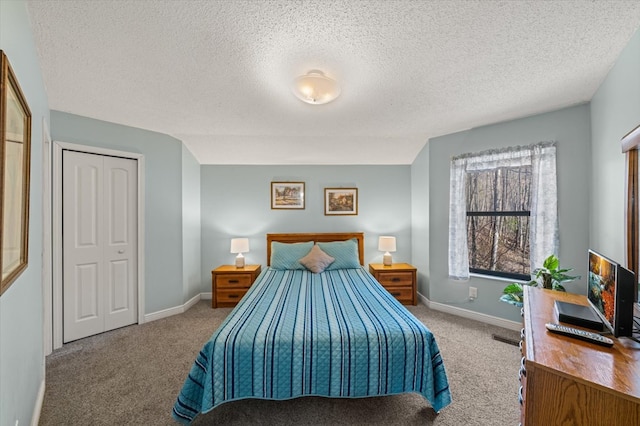 carpeted bedroom with vaulted ceiling, a closet, and a textured ceiling