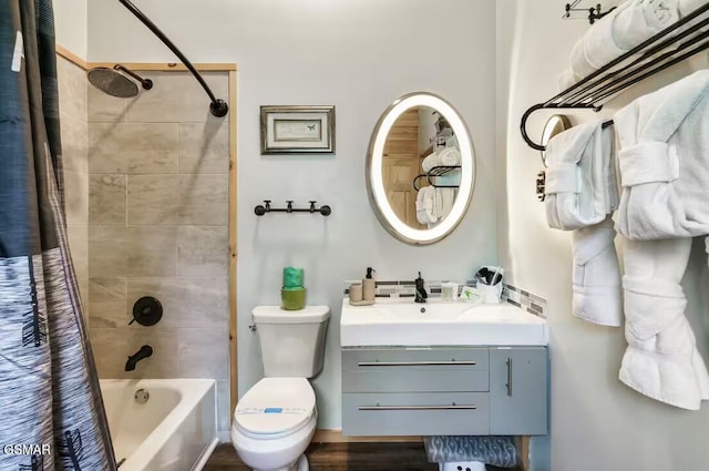 full bath featuring toilet, shower / bath combo with shower curtain, and vanity