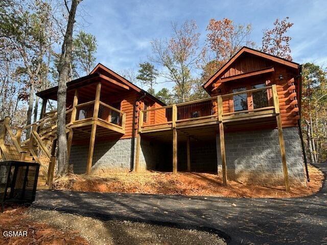 back of house with a balcony and a deck