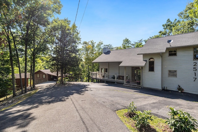2517 Angler Way, Sevierville, TN 37876 - rear view of house featuring a chimney, a porch, and a shingled roof