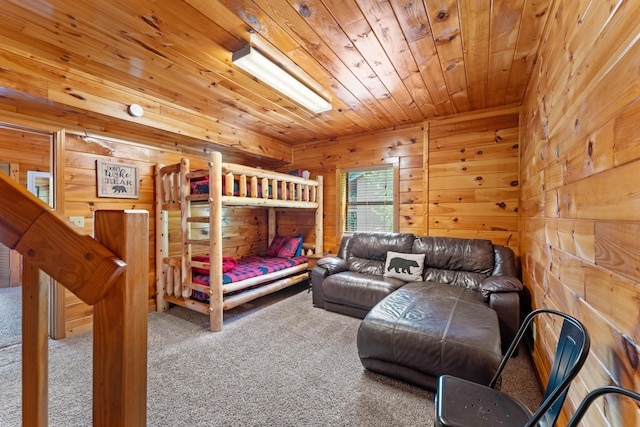 bedroom with wood ceiling, wood walls, and carpet