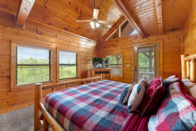 carpeted bedroom featuring lofted ceiling with beams, multiple windows, wood walls, and wood ceiling