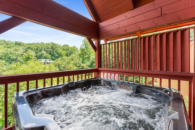 wooden deck featuring a hot tub