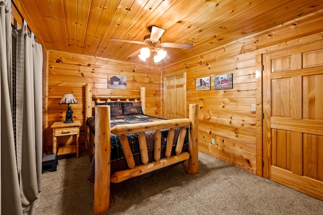 bedroom featuring ceiling fan, wood ceiling, and dark colored carpet