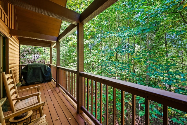 wooden terrace featuring a grill