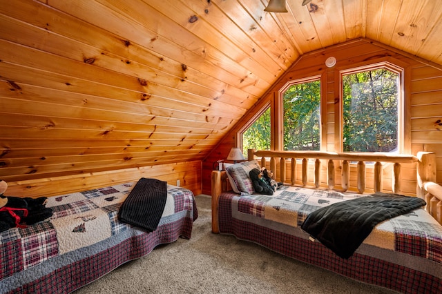 carpeted bedroom with lofted ceiling, wood ceiling, and wooden walls