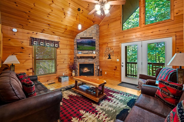 living room with ceiling fan, high vaulted ceiling, wooden ceiling, a fireplace, and hardwood / wood-style floors