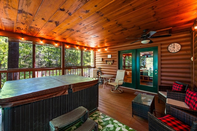 sunroom / solarium with ceiling fan and a hot tub