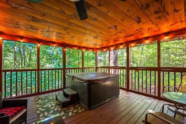 sunroom with a hot tub and wooden ceiling