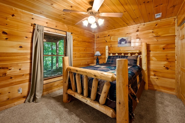 carpeted bedroom with ceiling fan, wooden ceiling, and wood walls