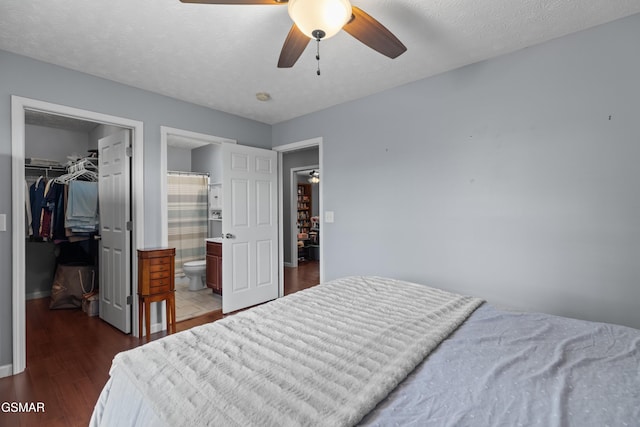 923 Red Oak Ln, Dandridge, TN 37725 - bedroom featuring a walk in closet, dark wood-type flooring, ensuite bath, and a ceiling fan