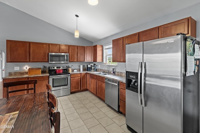 923 Red Oak Ln, Dandridge, TN 37725 - kitchen featuring stainless steel appliances, vaulted ceiling, light tile patterned floors, pendant lighting, and brown cabinetry