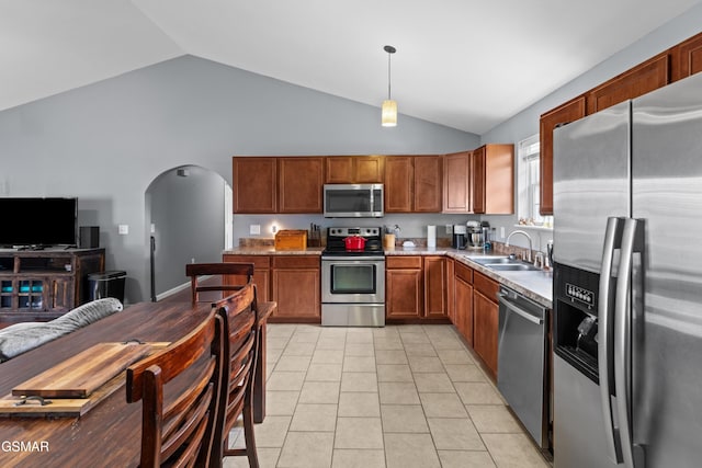 923 Red Oak Ln, Dandridge, TN 37725 - kitchen with stainless steel appliances, arched walkways, light countertops, brown cabinets, and light tile patterned floors