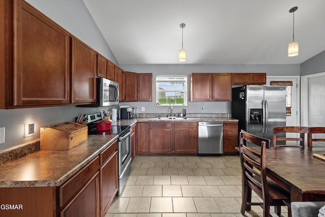 923 Red Oak Ln, Dandridge, TN 37725 - kitchen with stainless steel appliances, vaulted ceiling, light tile patterned floors, dark countertops, and hanging light fixtures