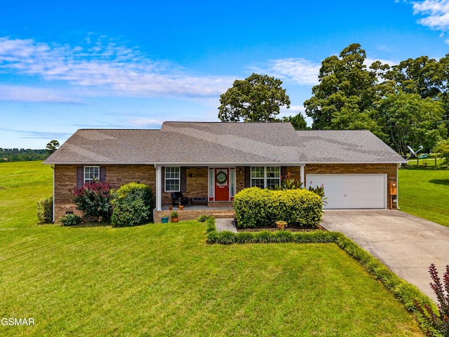 923 Red Oak Ln, Dandridge, TN 37725 - view of front of home featuring covered porch, concrete driveway, a garage, a front lawn, and brick siding