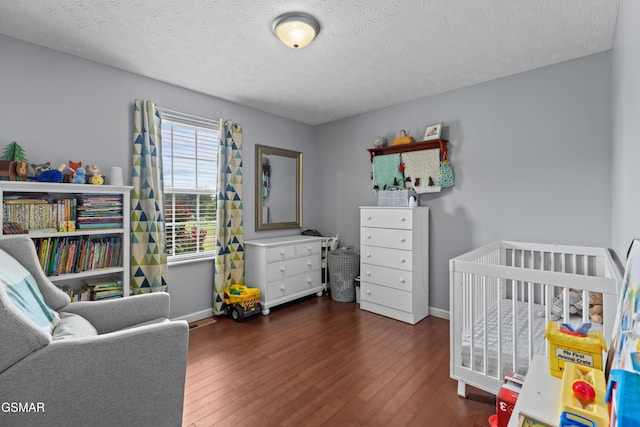 923 Red Oak Ln, Dandridge, TN 37725 - bedroom featuring wood finished floors, a nursery area, and a textured ceiling