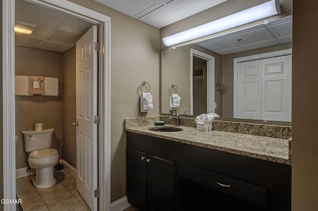 3215 N River Rd Unit 103, Pigeon Forge, TN 37863 - bathroom with toilet, vanity, tile patterned floors, and baseboards
