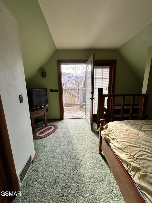 carpeted bedroom with access to outside and lofted ceiling