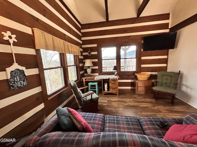 living area with wood walls, wood-type flooring, and a high ceiling