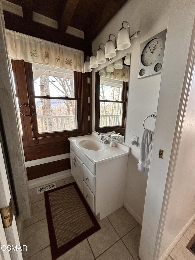 bathroom featuring tile patterned flooring, vanity, and plenty of natural light