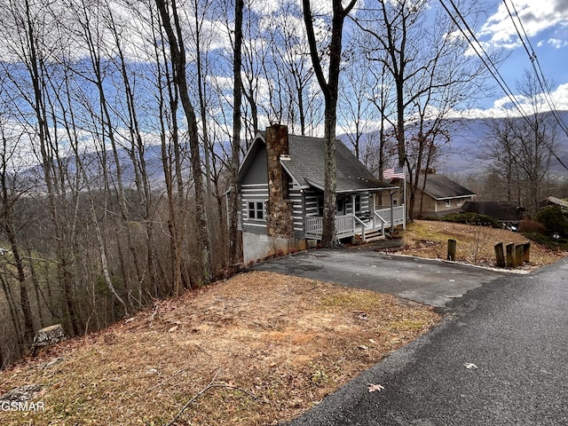 view of side of home featuring covered porch