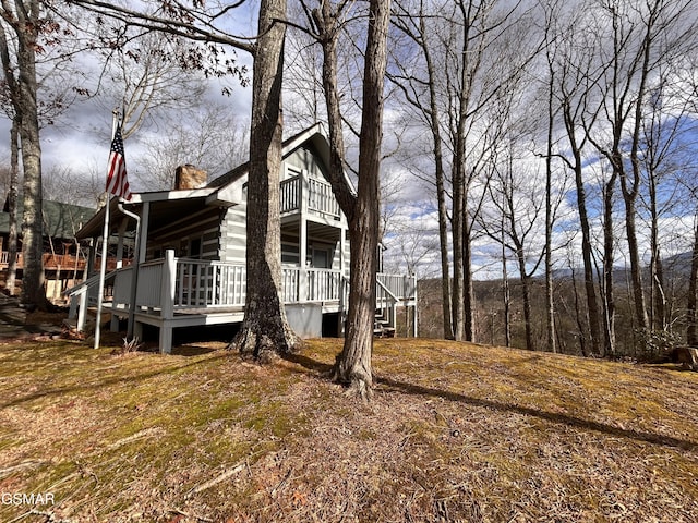 view of side of home with a balcony